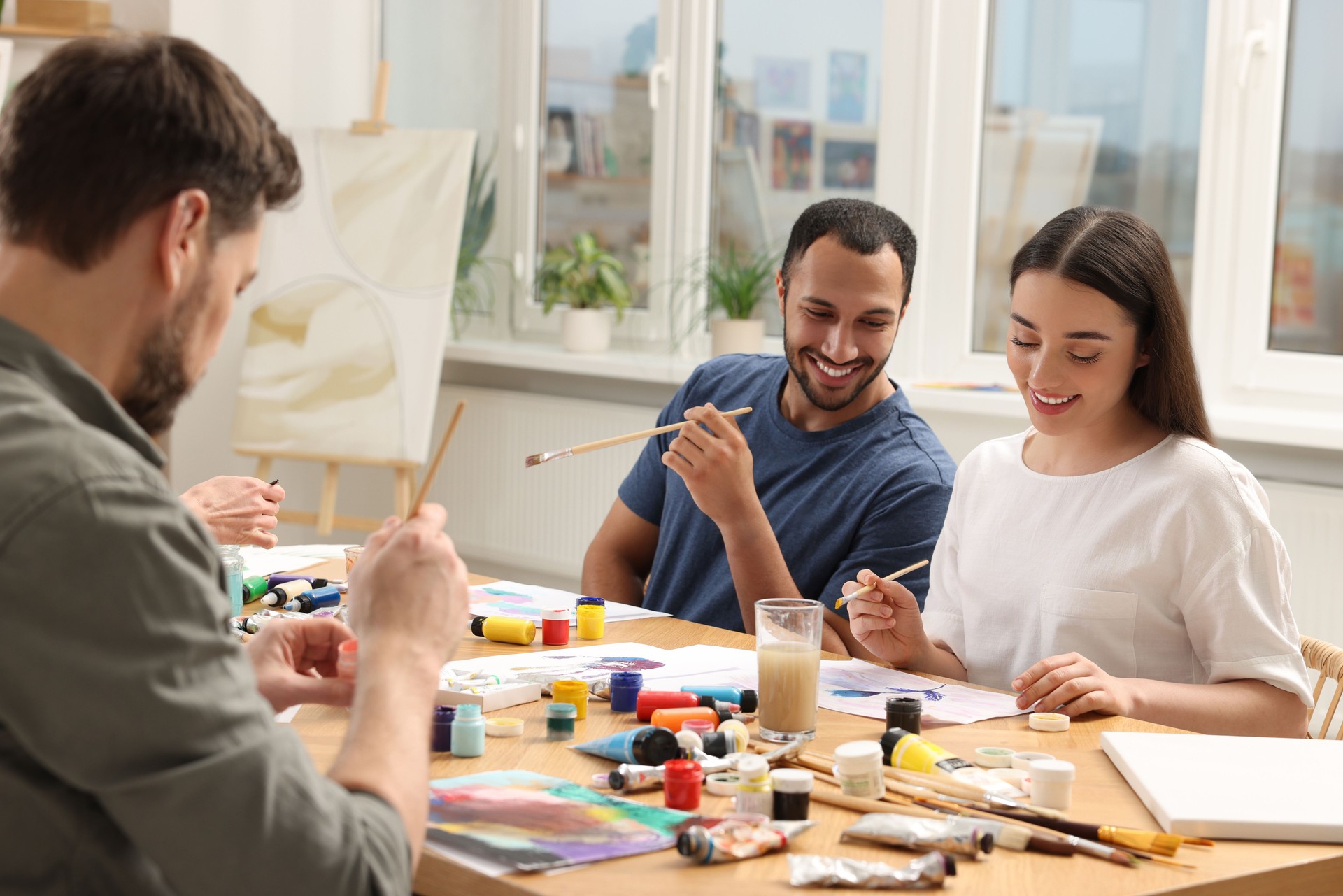 Group of students attending painting class in studio. Creative hobby